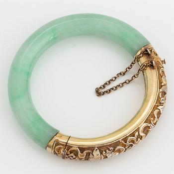 A jadeite and silver bracelet.