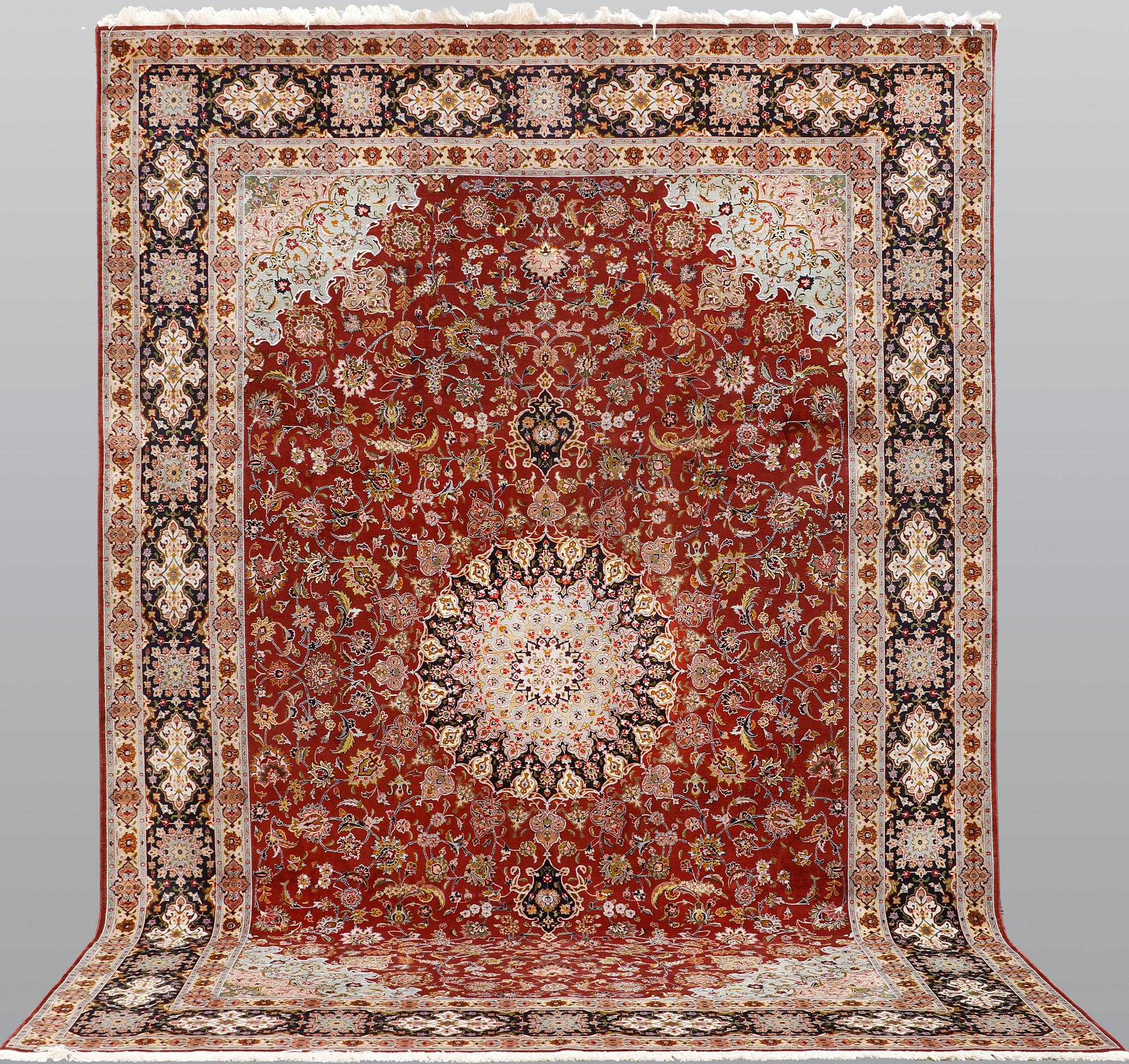 A Tabriz carpet, part silk, so-called 50 Raj, approx. 352 x 250 cm.