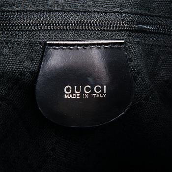 GUCCI, a black nylon handbag.