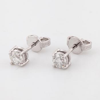 A pair of brilliant cut diamond earrings.