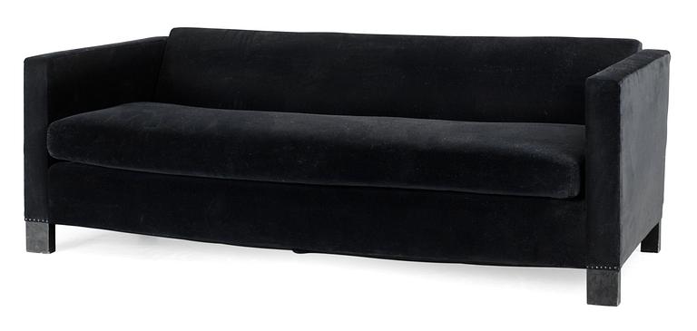 An Uno Åhrén black velvet and stained birch sofa by Firma Svenskt Tenn, circa 1930.