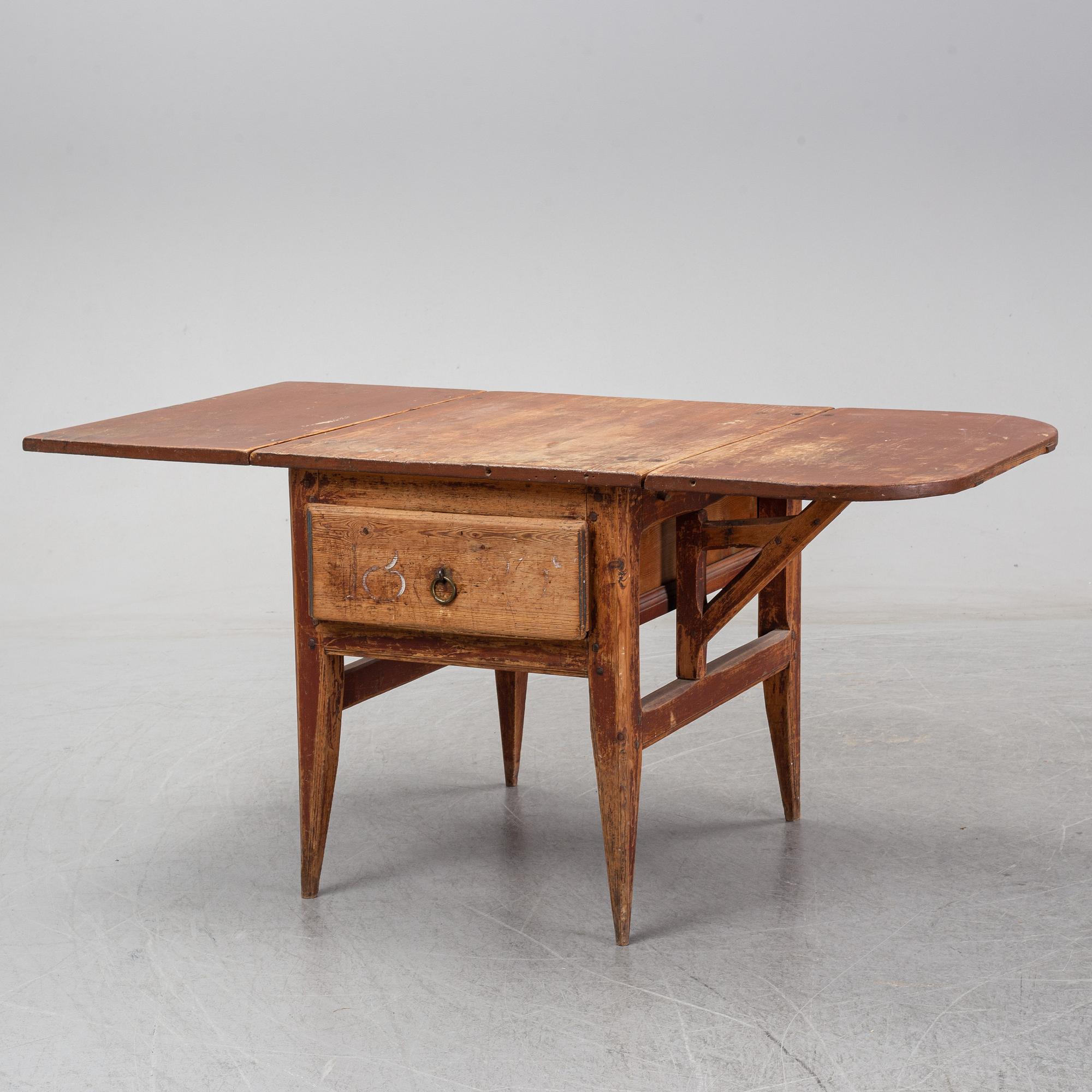A 19th Century table with drop leaves.