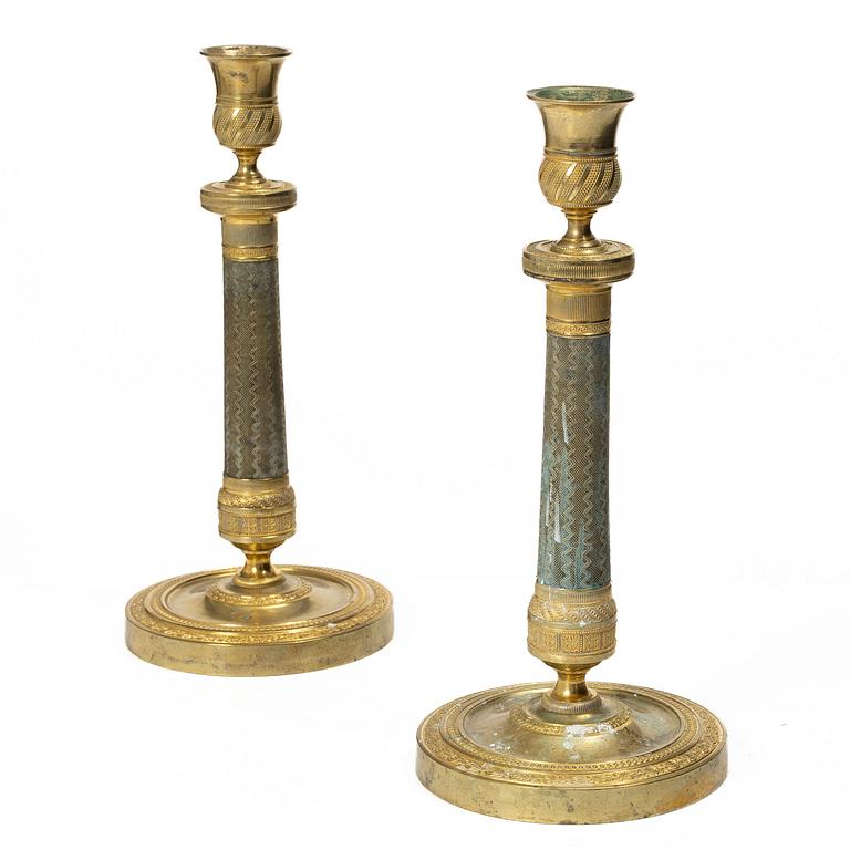 A pair of French Empire ormolu candlesticks, early 19th century.