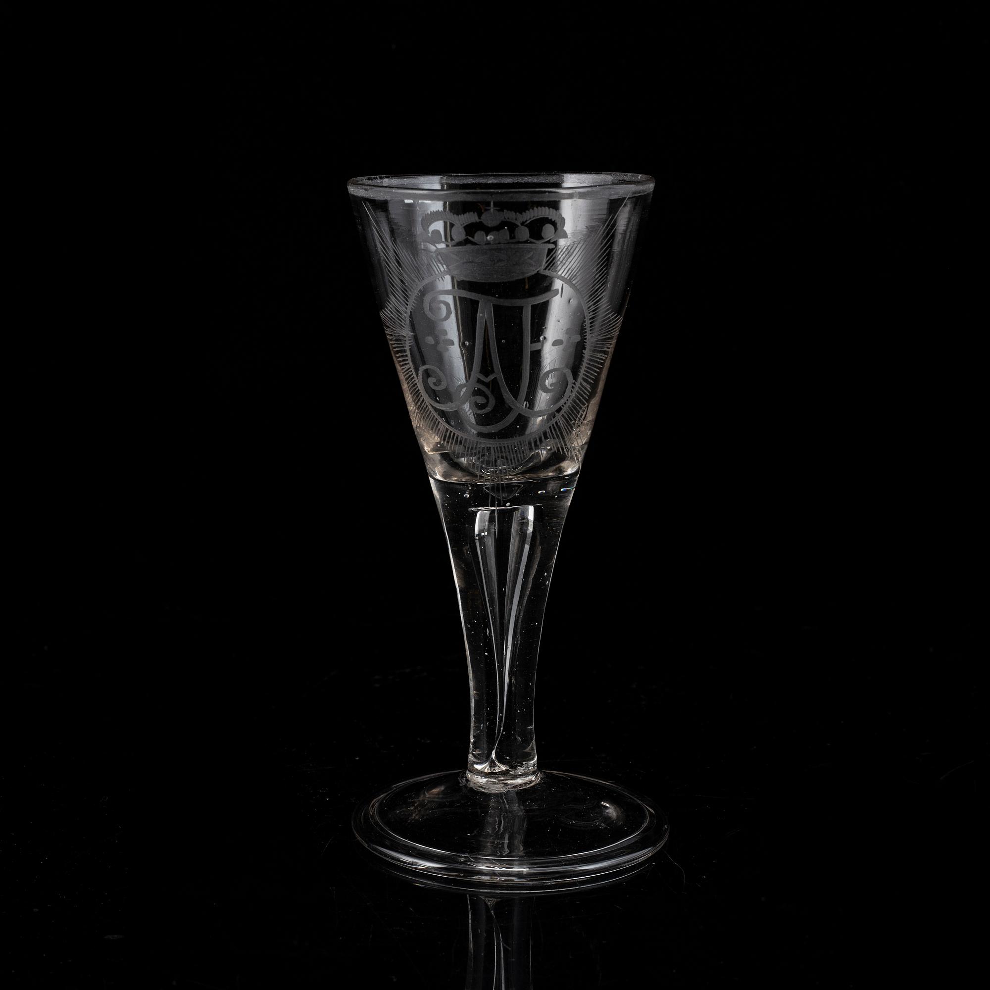 A wine glass with the monogram of the Swedish king Adolf Frederick, 18th Century.