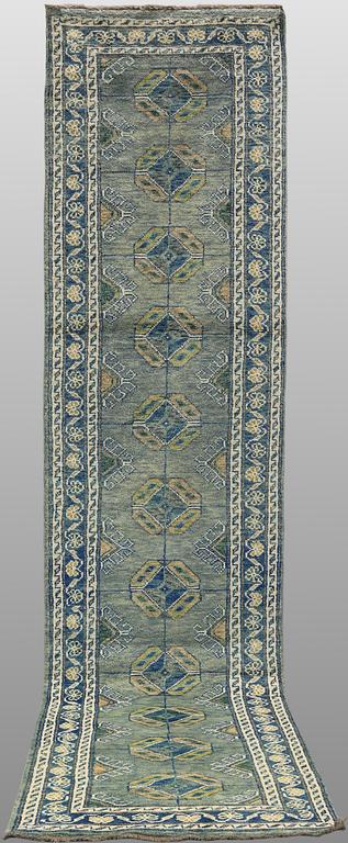 An Oriental runner, c. 393 x 79 cm.