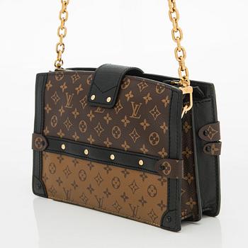 Louis Vuitton, a "Reverse Monogram Trunk Clutch" bag.
