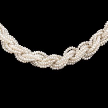 A necklace of cultured pearls and seed pearls with a silver clasp decorated with probably synthetic rubies.