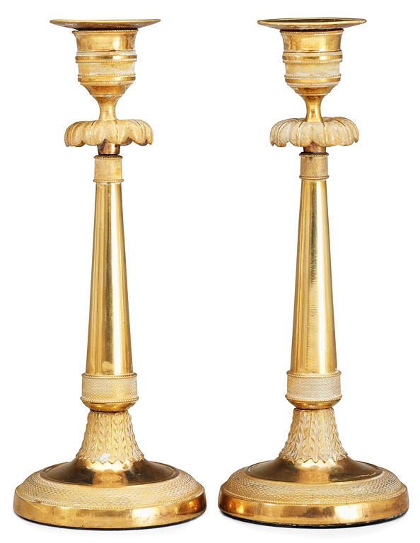 A pair of late Gustavian gilt bronze candlesticks.