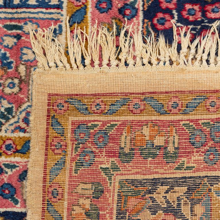An carpet, possibly Kirman, signed, 350 x 255 cm.