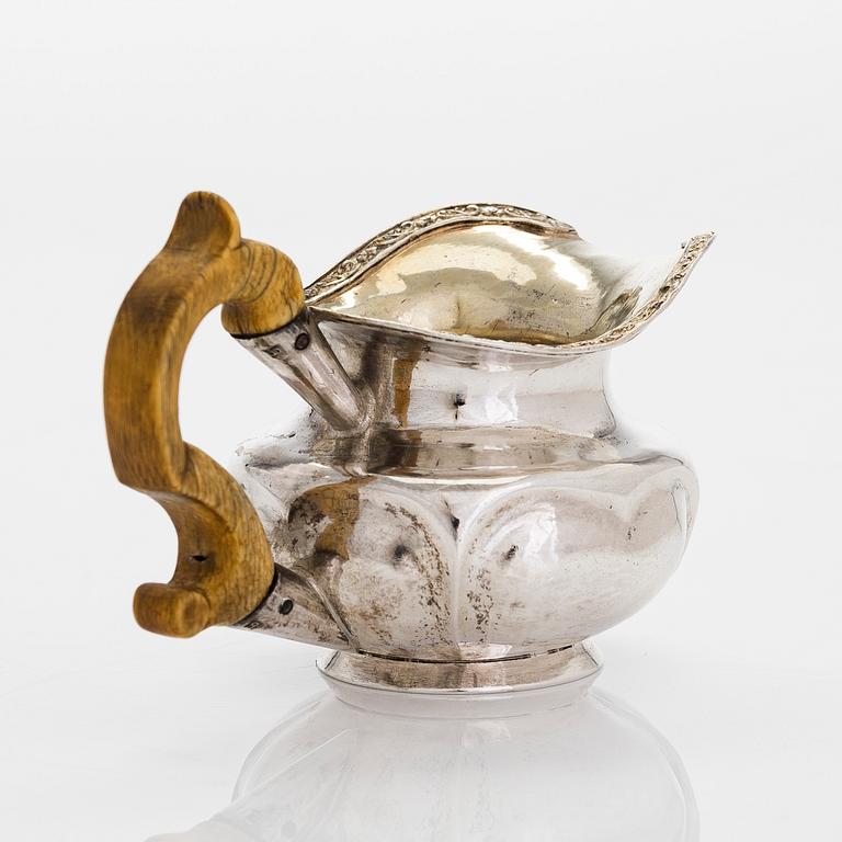 A silver ladle and cream jug,Johan Illberg, Viborg 1852, and unidentified master from Moscow, 1843.