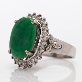 A palladium-plated silver ring with cabochon-cut jadeite and diamonds.
