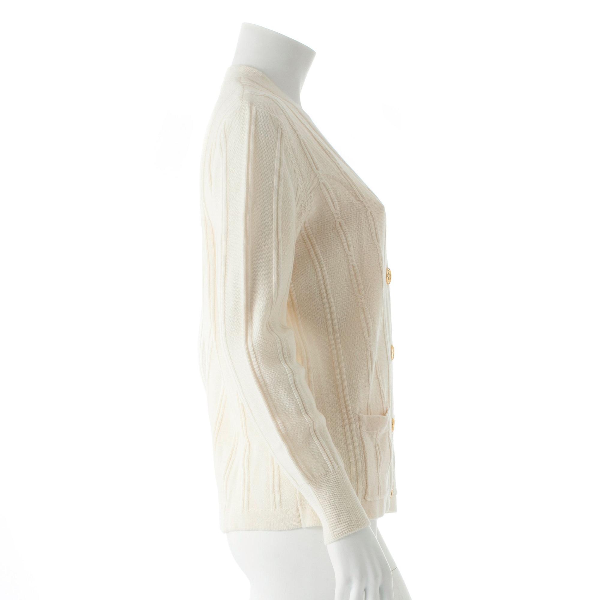 CÉLINE, a white wool cardigan.