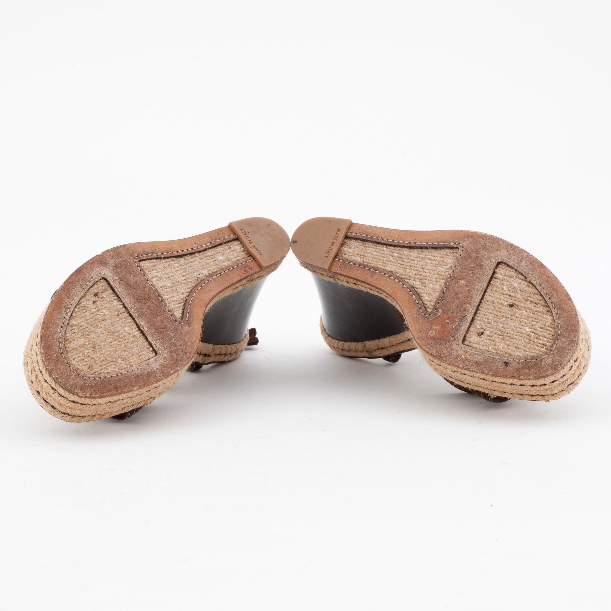 LOUIS VUITTON, a pair of straw and brown leather wedge sandals.