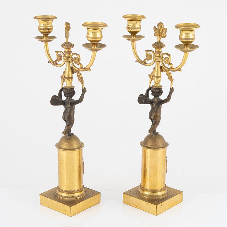 A pair of North European ormolu and patinated bronze two-light candelabra, earlt 19th century.
