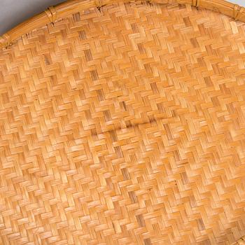 A mid-20th century rattan basket and two rattan trays. Retailer Artek Finland.