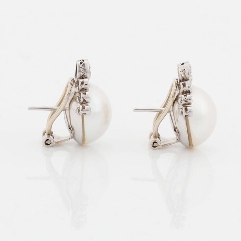 A pair of 18K white gold earrings set with mabe pearls and round brilliant-cut diamonds.