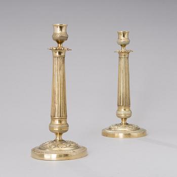 A pair of Empire bronze candlesticks from the first half of the 19th century.