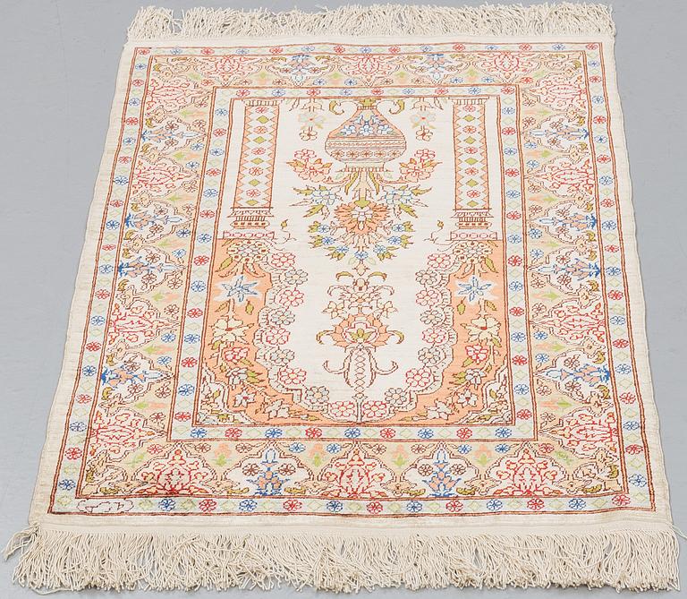 A RUG, Silk, Hereke, PROBABLY 82 x 54 cm.