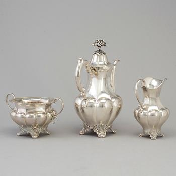 A three piece silver coffee set dated 1916-17.