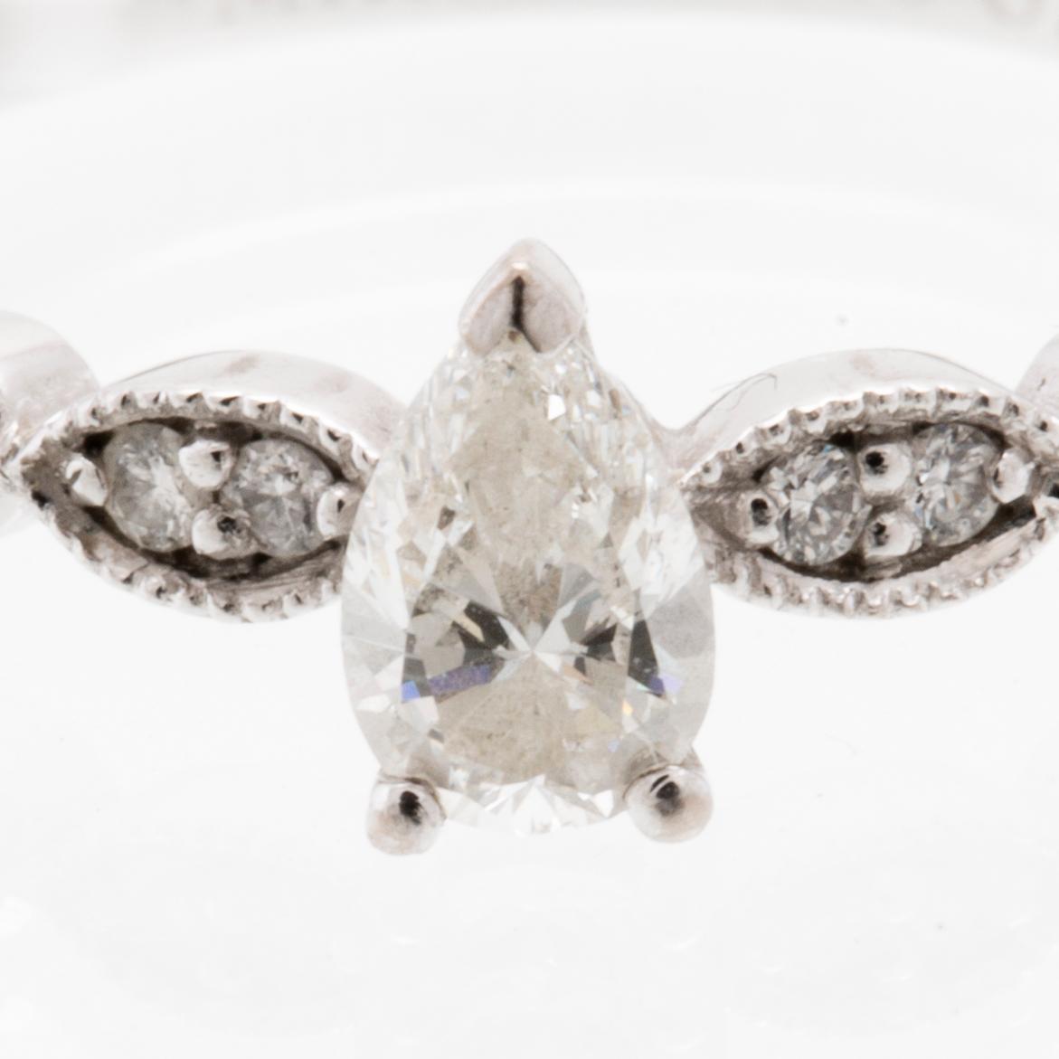 Ring in 18K white gold set with a pear-shaped diamond and round brilliant-cut diamonds, Van Bruun.