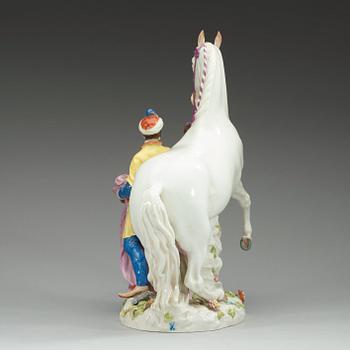 A large Meissen figure of a white horse and his groom, 20th Century.