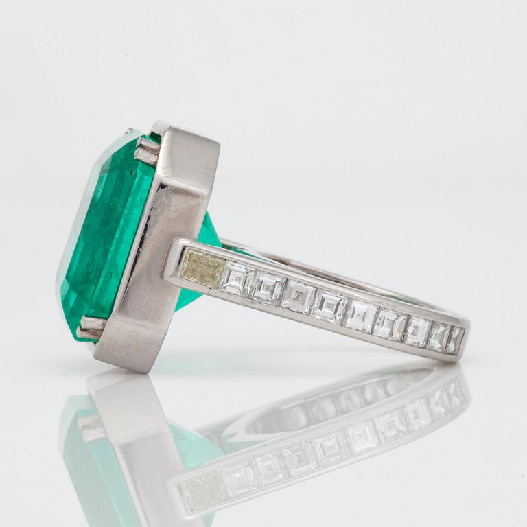 A 26.60ct emerald-cut Colombian emerald and radiant- and step-cut diamond ring.