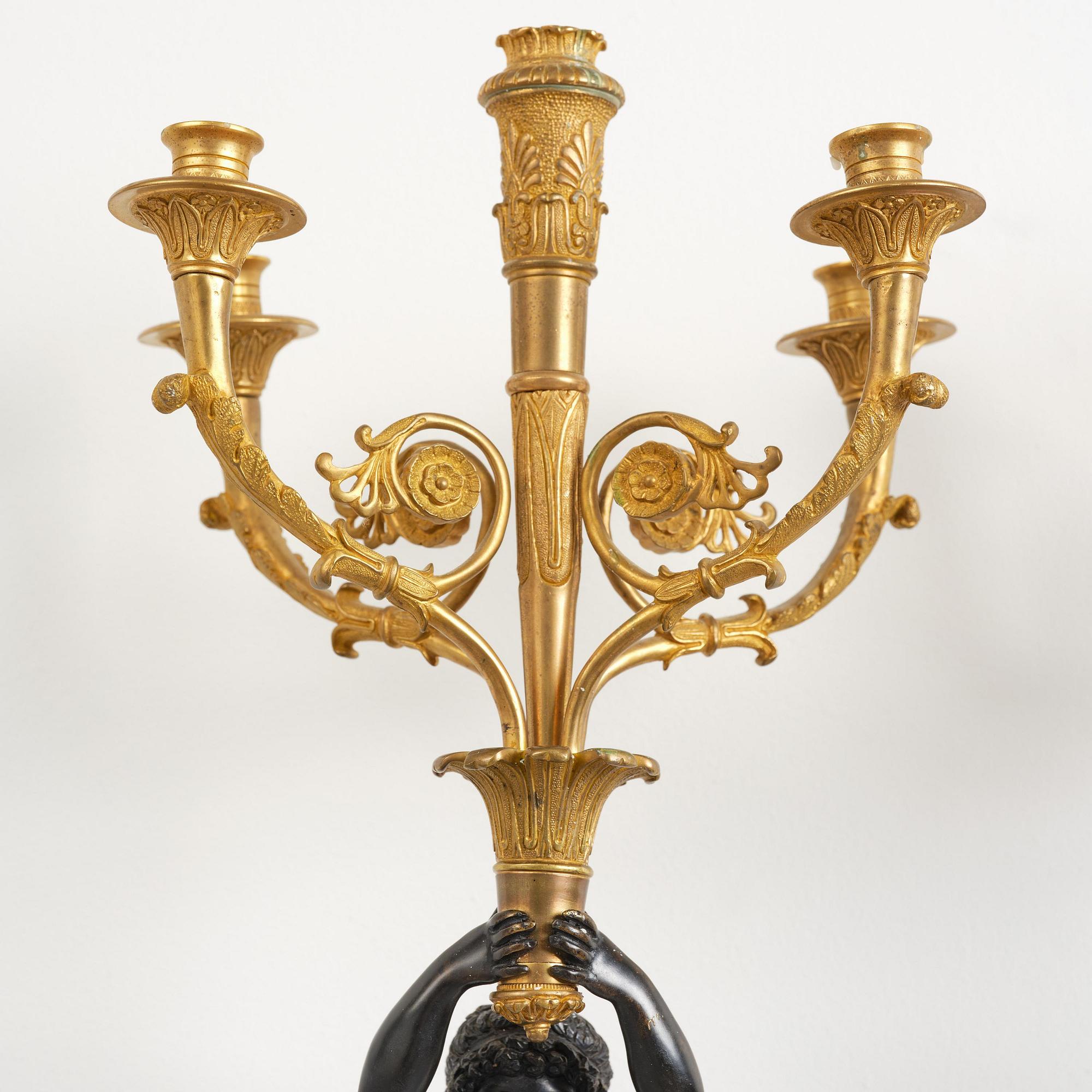 A pair of Napoleon III five-branch gilt and patinated bronze appliques.