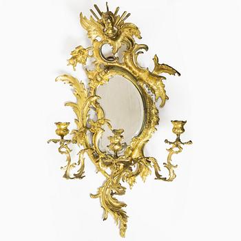 A Rococo style mirror wall sconce, France, early 20th century.