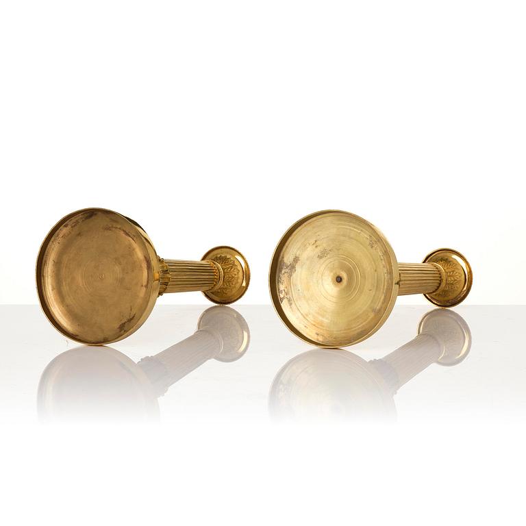 A pair of French Empire gilt-bronze candlesticks, early 19th century.