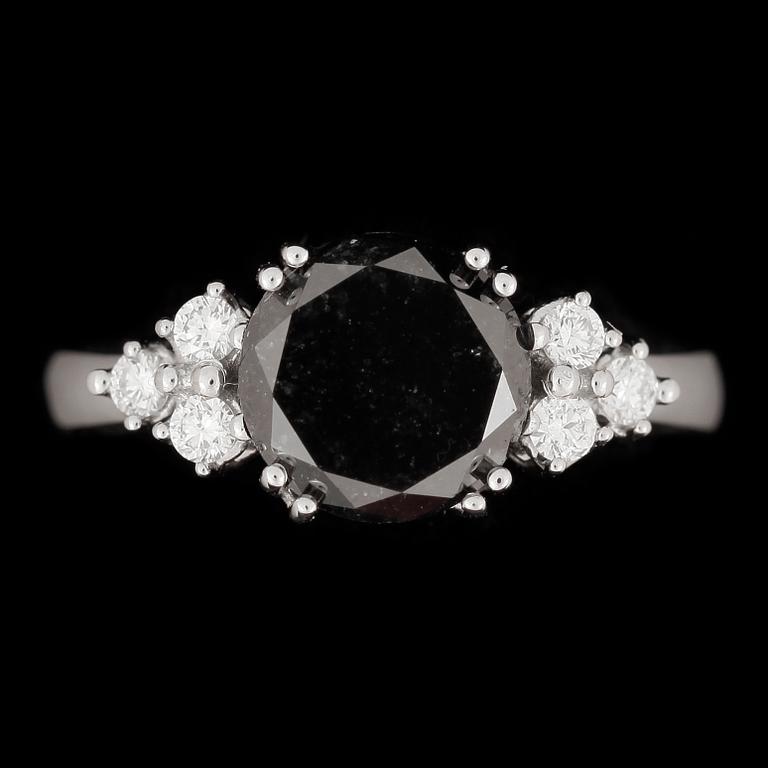 RING, 18k vitguld med briljantslipad färgad svart diamant ca 3,00 ct samt 6 st diamanter tot ca 0,20 ct. Vikt ca 6,55 g.