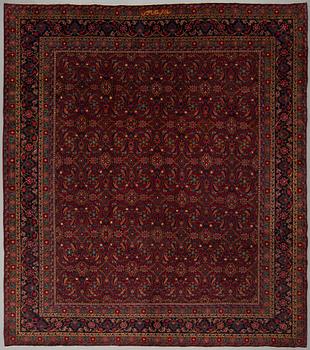 A CARPET, semi-antique Mashad, signed, around 360 x 320 cm.