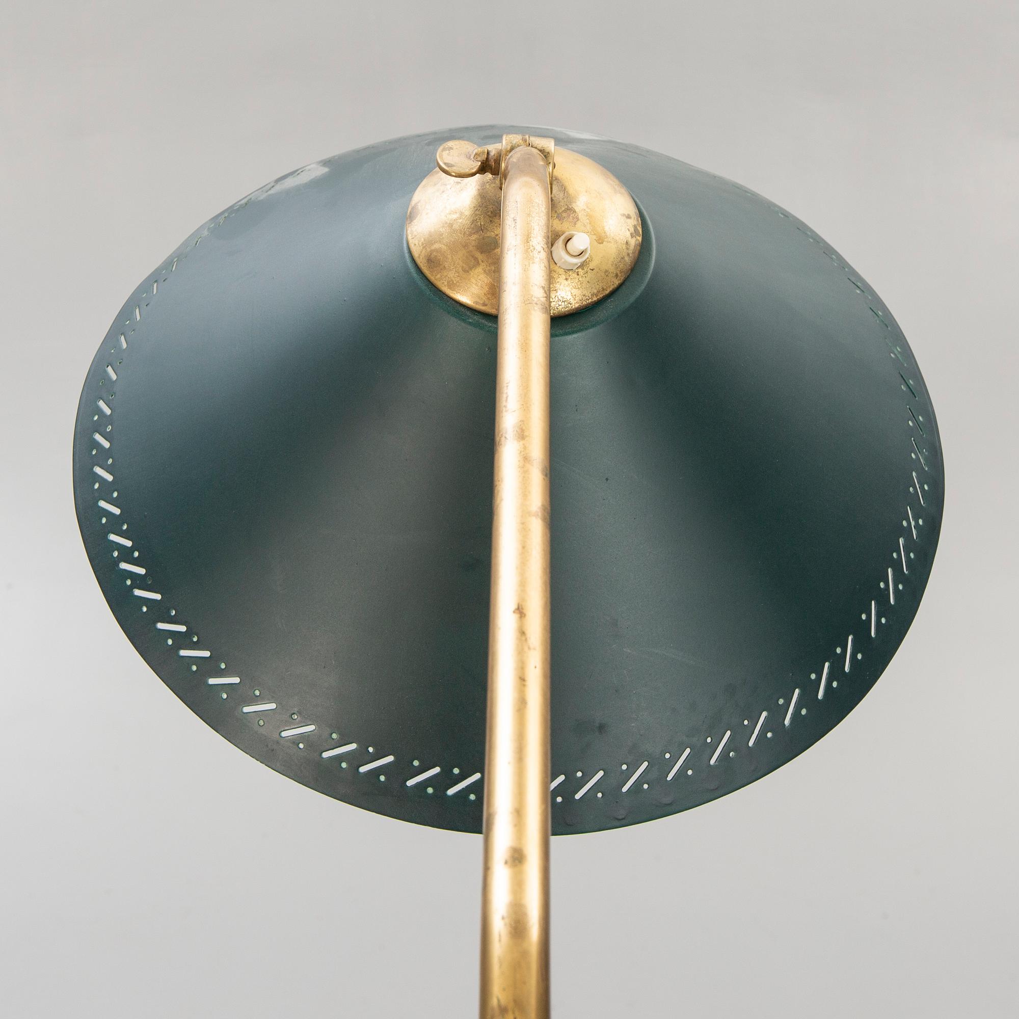 A 1950s brass floor lamp.
