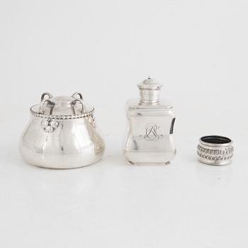 A silver tea caddy, a sugarbowl and a napkin ring, including K. Anderson, Stockholm 1920.