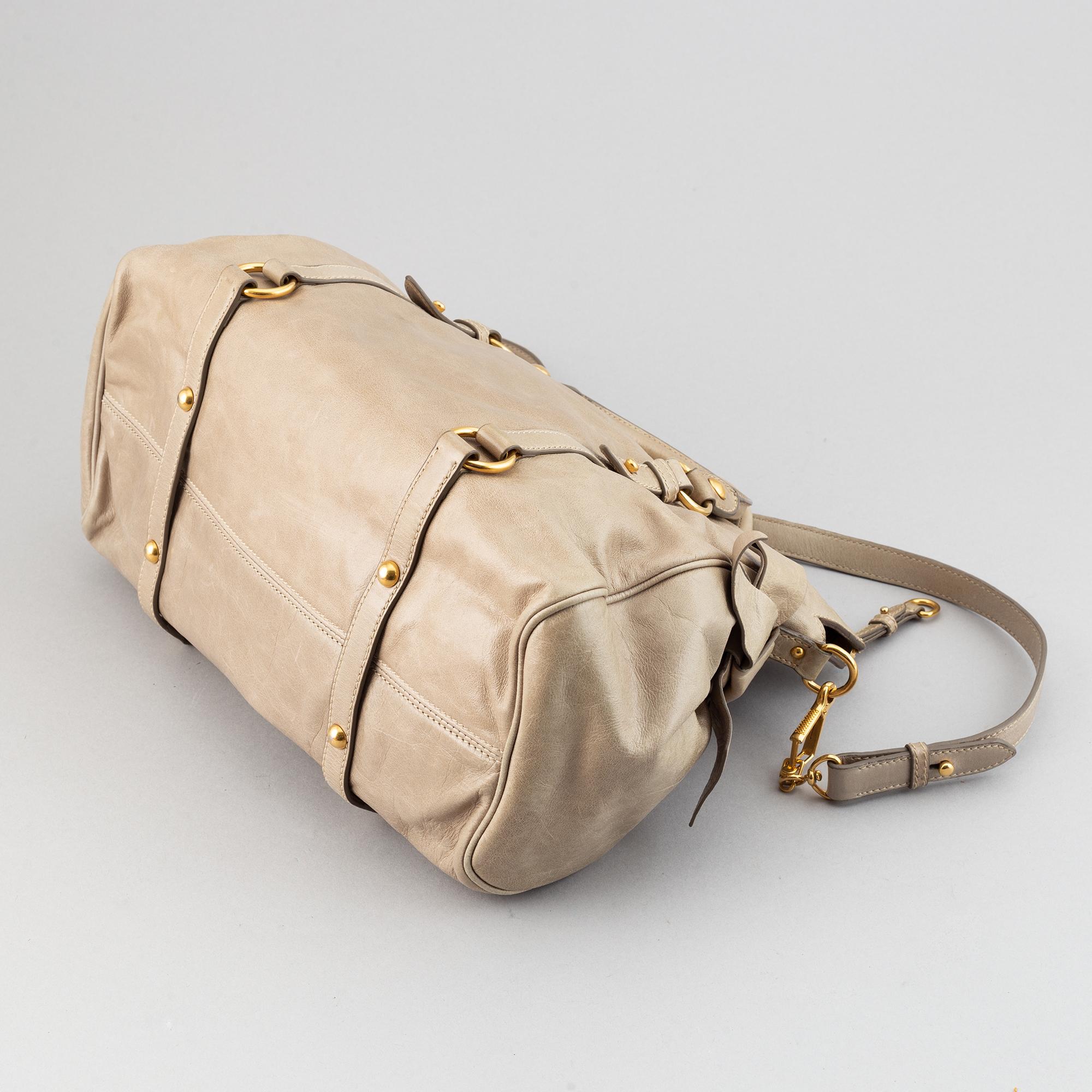 Miu Miu, a leather handbag.