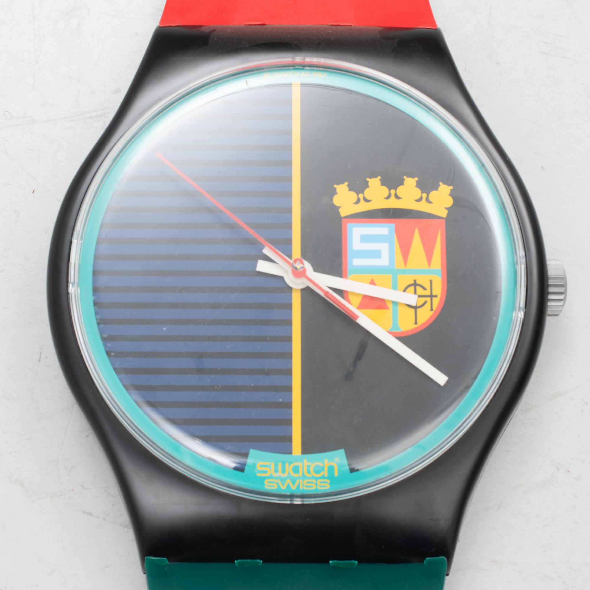 A wall clock, Swatch.