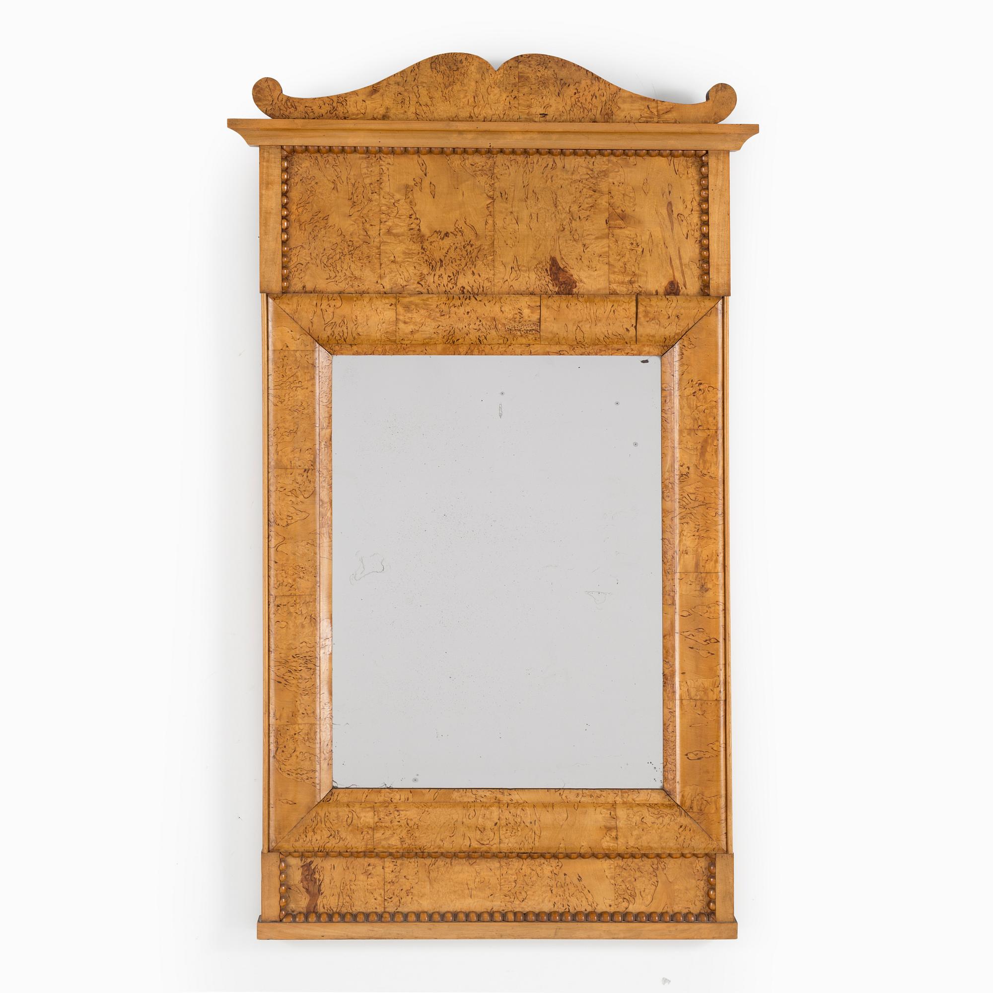 A birch veneered Swedish mirror, late empire, mid 19th Century.