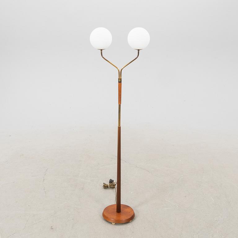 A mid 20th century teak and brass floor lamp.