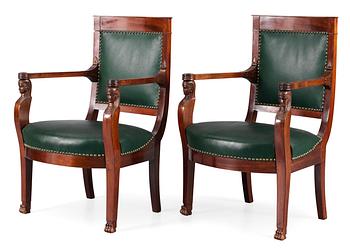 531. A pair of French Empire early 19th century armchairs.