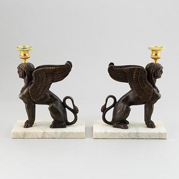 A pair of bronze and marble Empire style candlesticks, first part of the 20th Century.