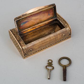 A brass music box, about 1900.