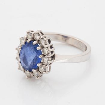 Oval faceted sapphire and brilliant-cut diamond ring.