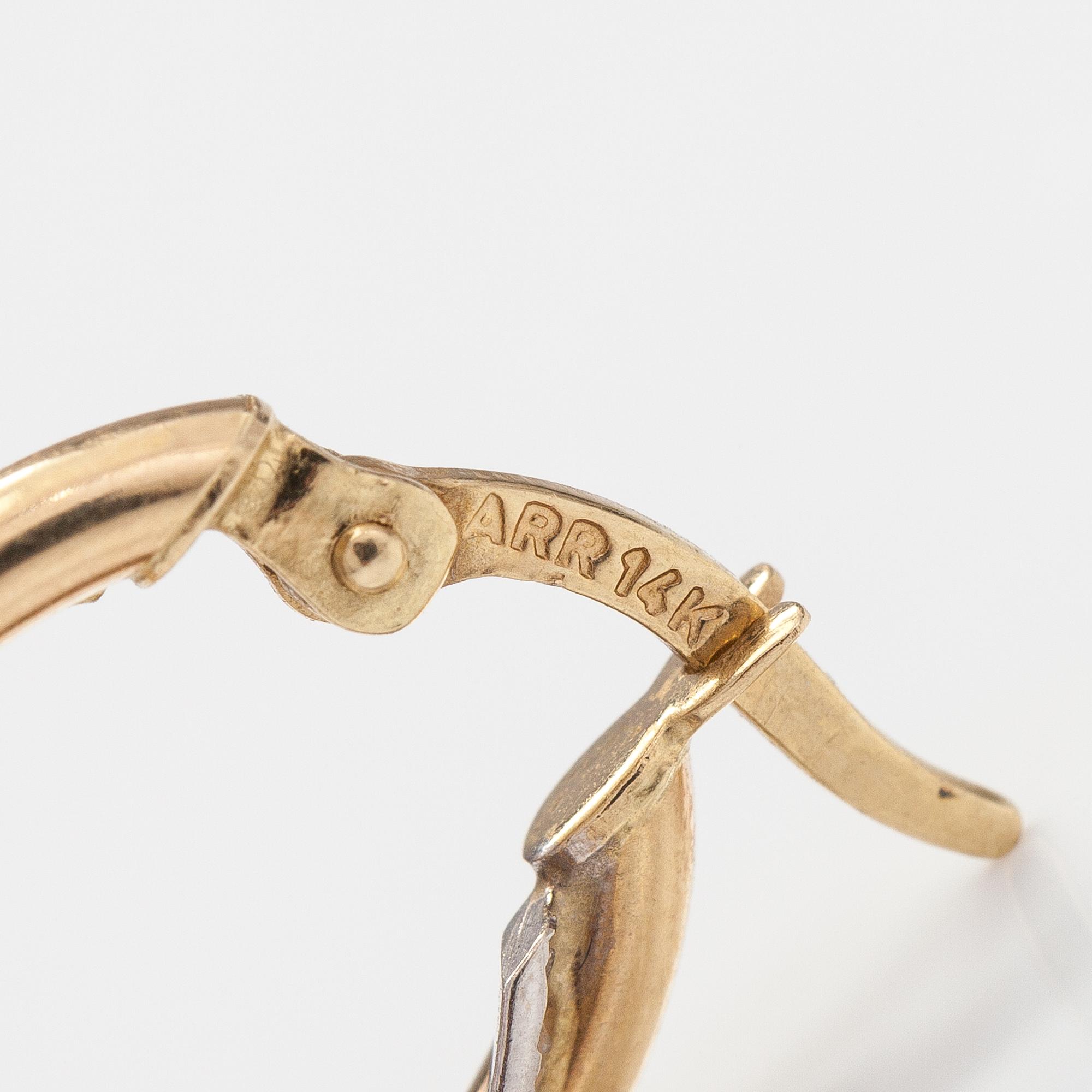 A pair of 14K gold earrings.