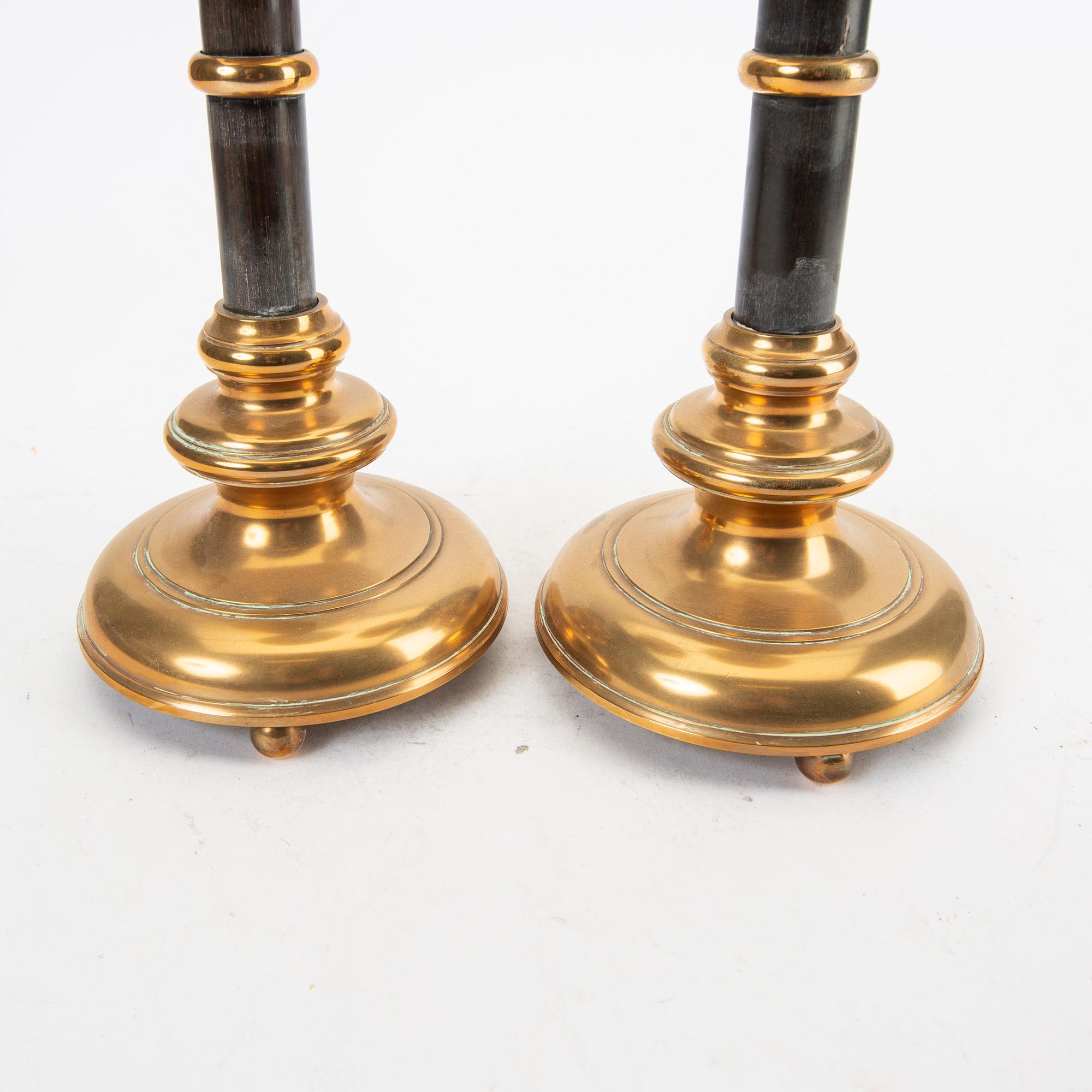 A pair of brass and wood candle sticks early 1900s.