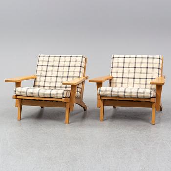HANS J WEGNER, a pair of oak easy chairs, Getama, Denmark.