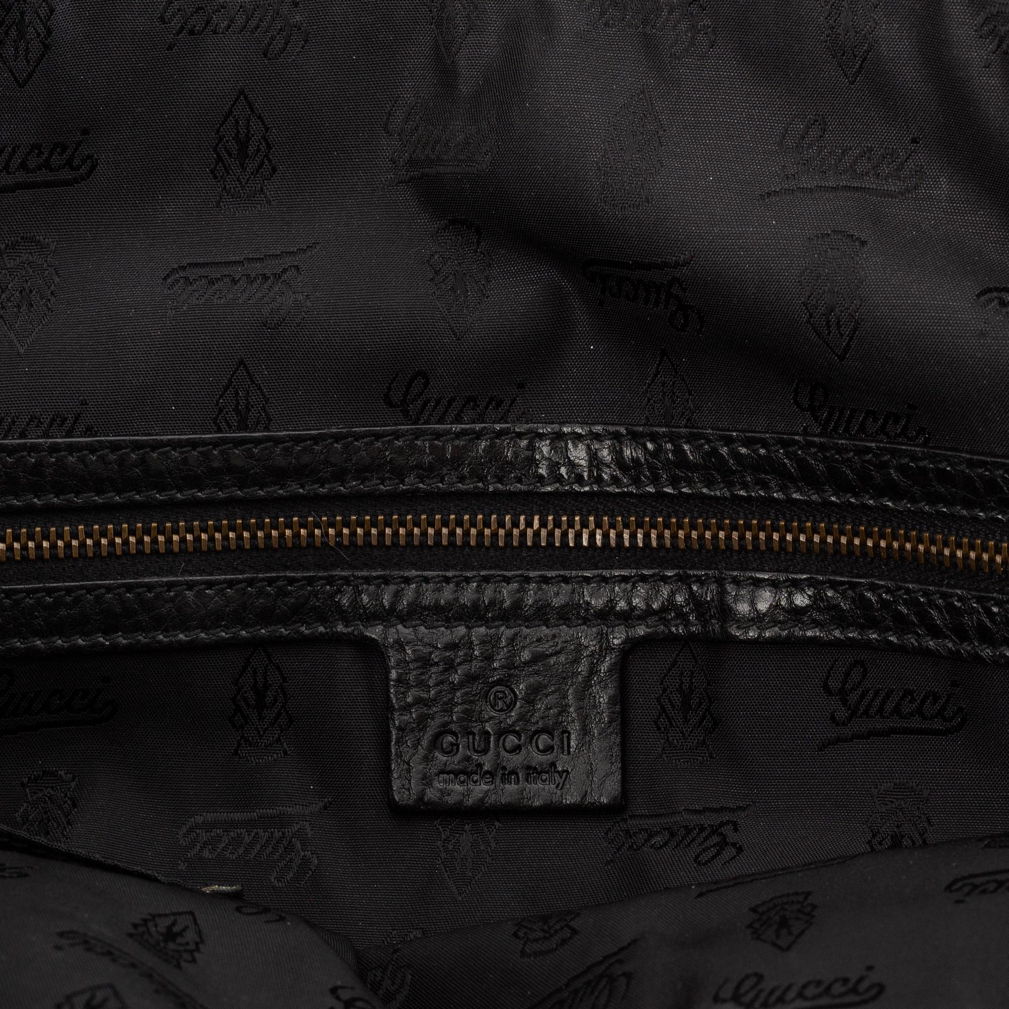 Gucci, a black leather handbag.