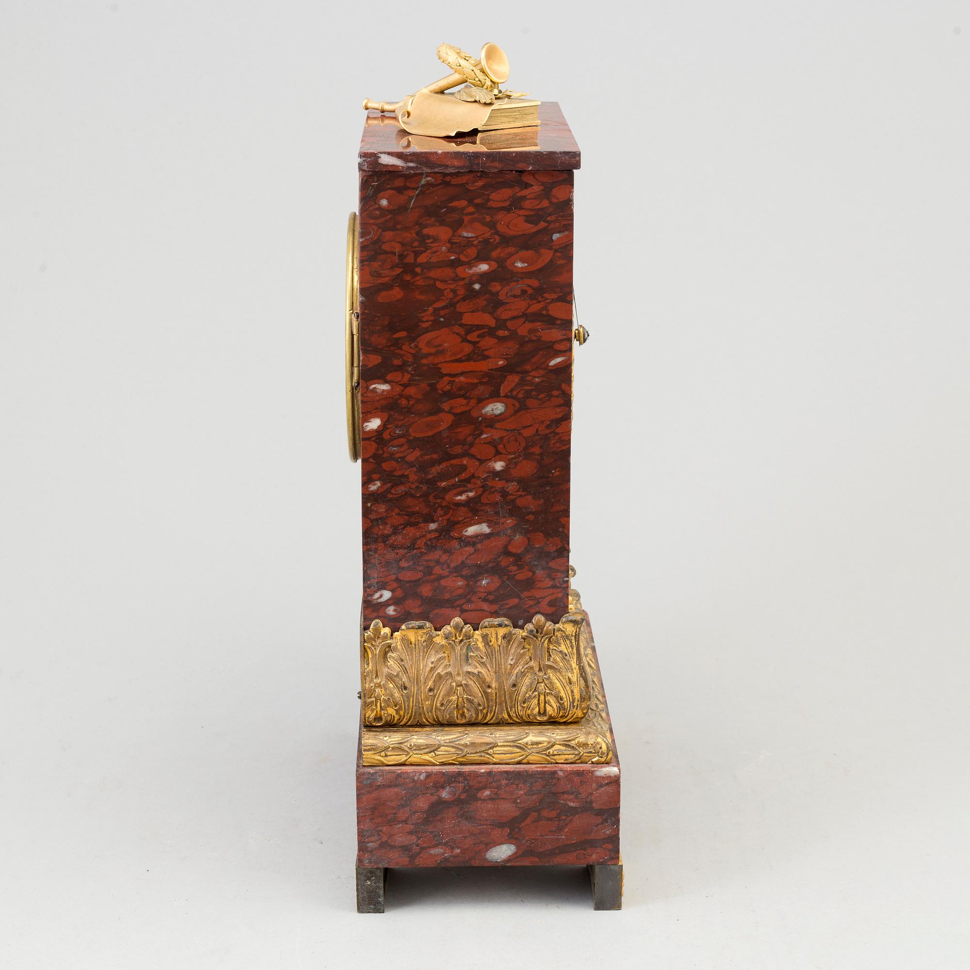 AN EMPIRE ORMOLU AND MARBLE MANTEL CLOCK, first half of the 19th century.