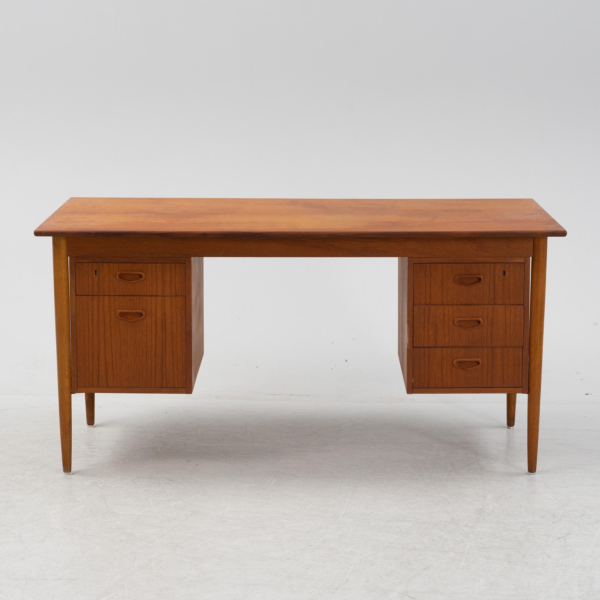 A teak veneered desk, 1950's/1960's.