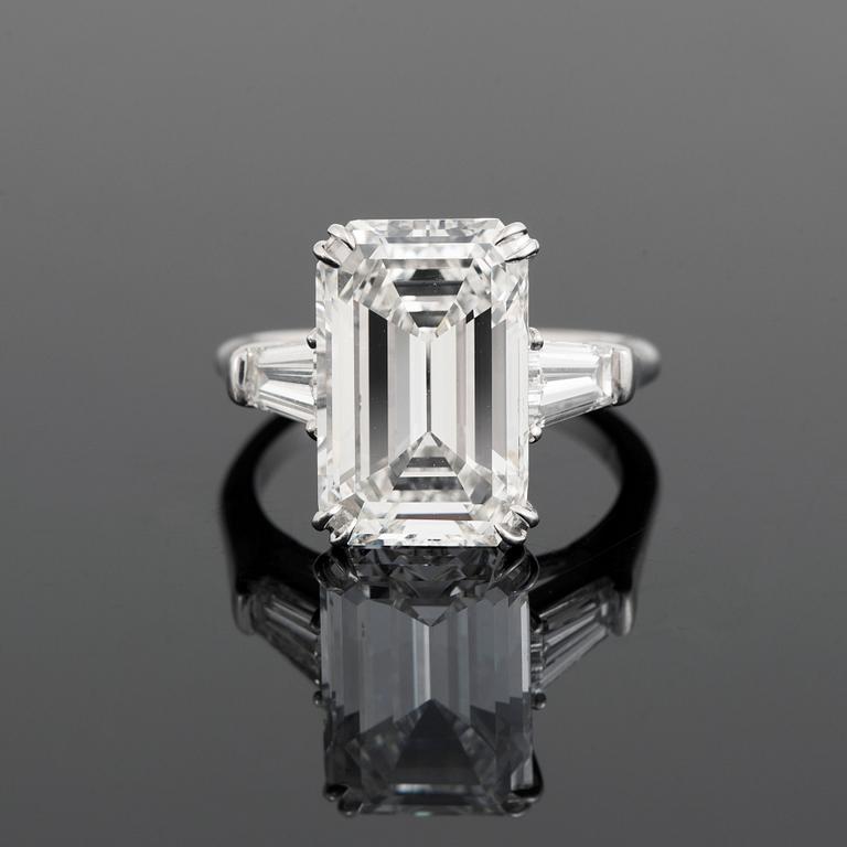 A platinum ring set with an emerald-cut diamond.