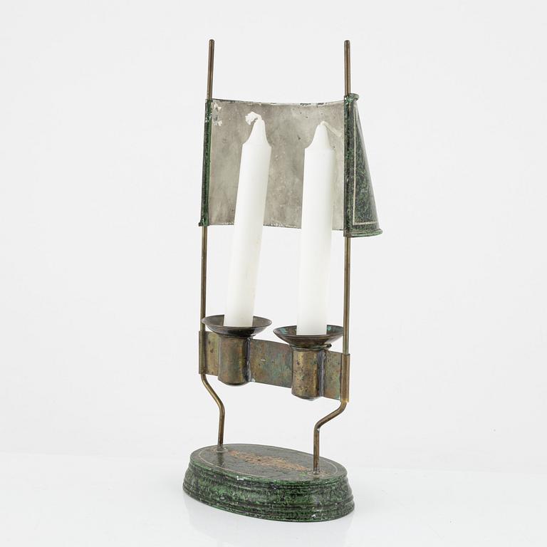 An empire style candlestick, circa 1900.