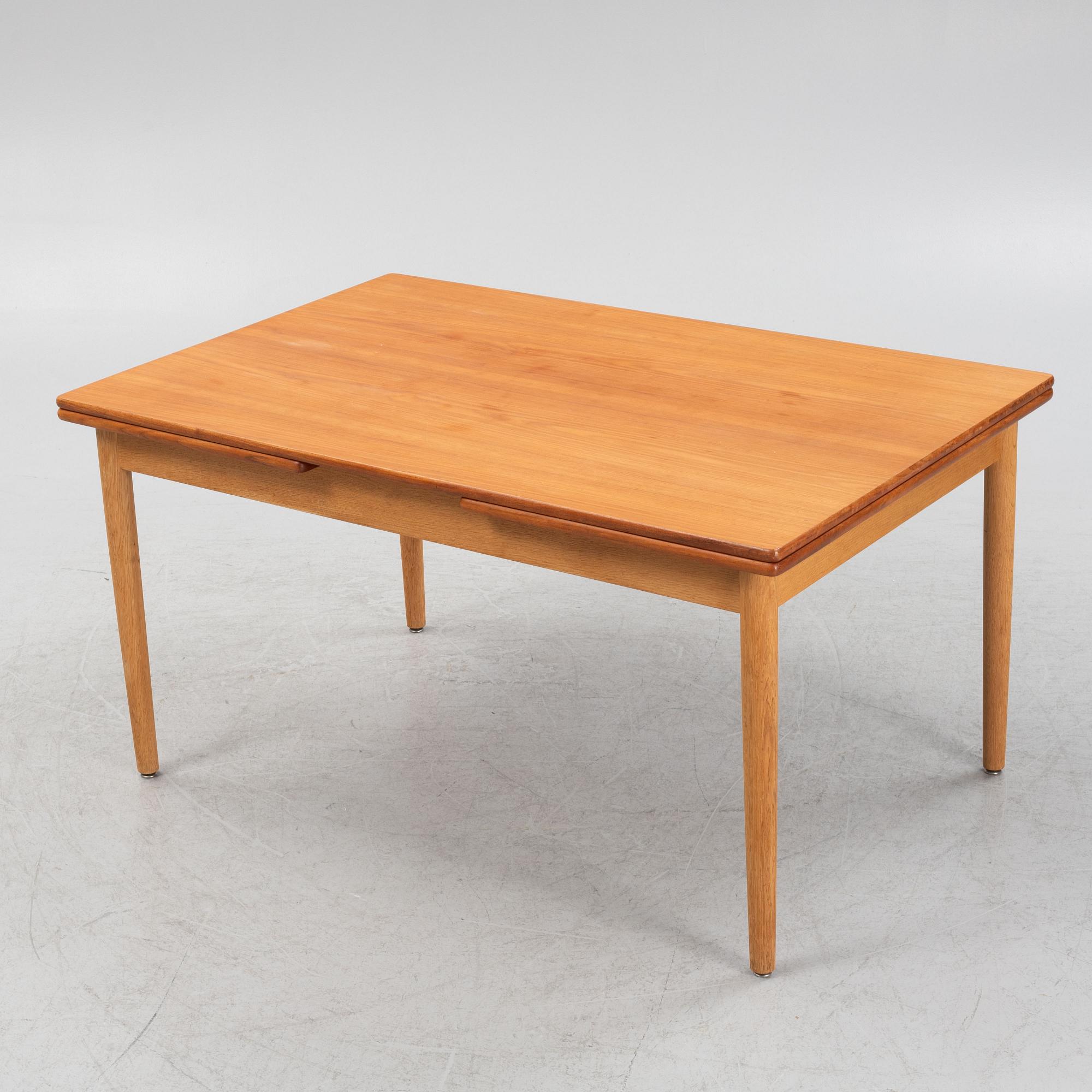 Hans J. Wegner, an oak and teak dinner table for Andreas Tuck. Denmark.
